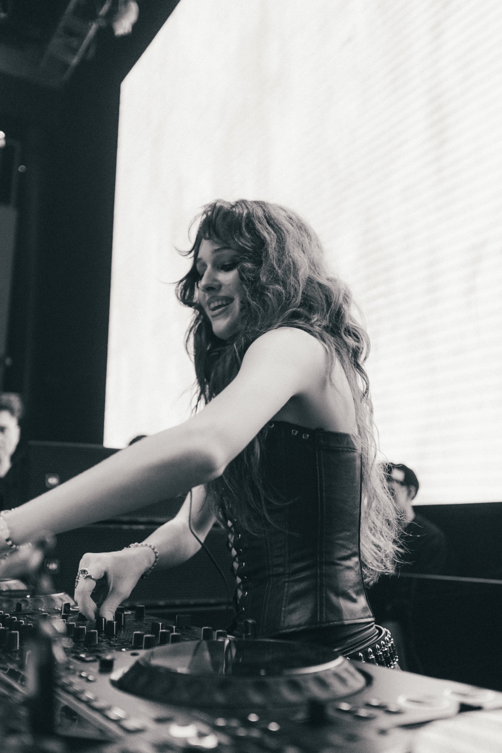 DJ Tasia performing in black and white